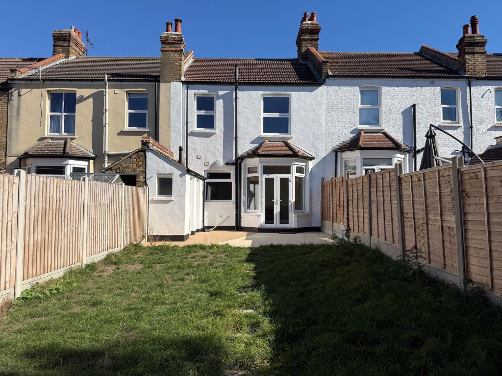 Lot: 132 - THREE-BEDROOM TERRACE HOUSE - Rear elevation of the terrace house and outbuildings